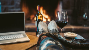 Feet Up on End table with Glass of Wine in front of fire